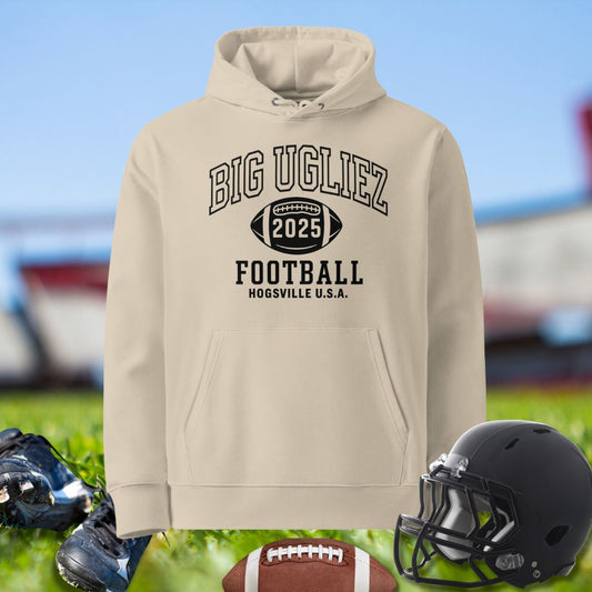 Beige hoodie with 'BIG UGLIEZ' text, football helmet, and shoes on a sports field background for Olineman