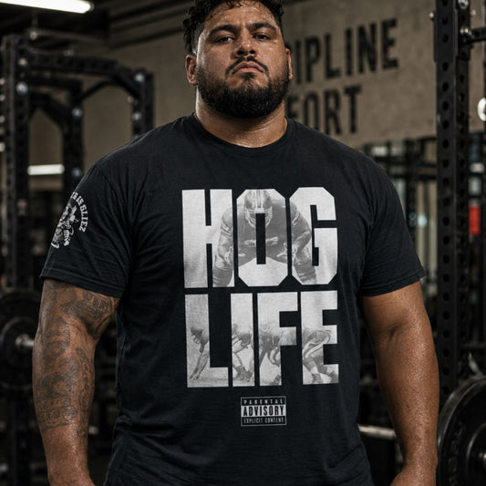 A man wearing a black tshirt with the words Hog_Life By Big Ugliez