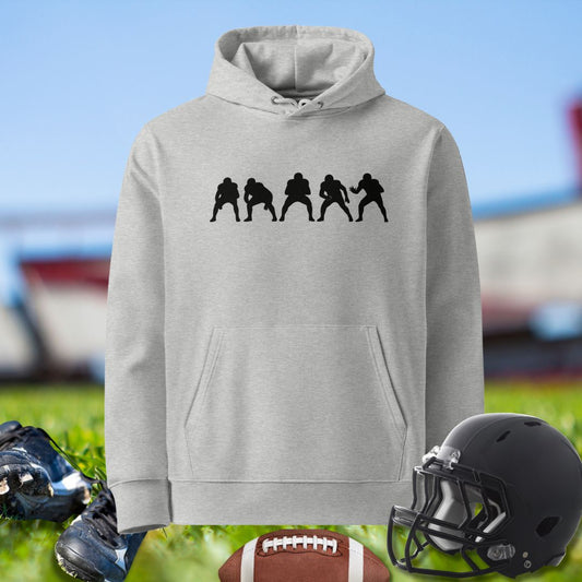 Gray hoodie with black graphic of football players, football, cleats, and helmet on grass. For the Olinemen.