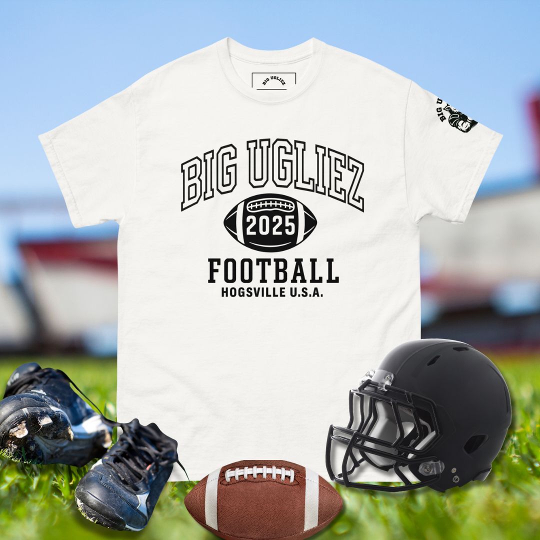 White t-shirt with 'BIG UGLIEZ 2025 FOOTBALL' text, black helmet, football, and cleats on grass.