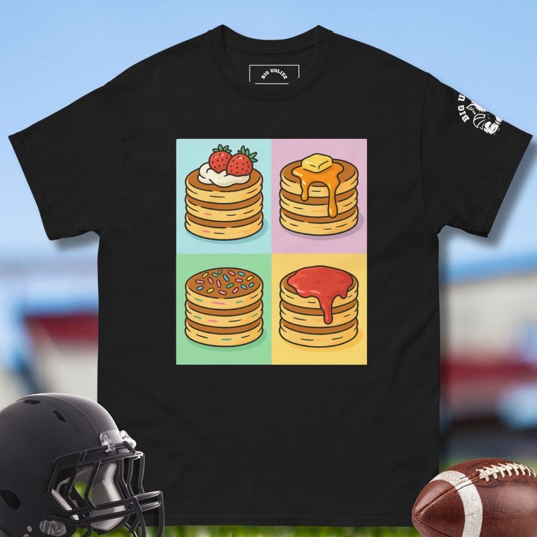 Black t-shirt with colorful stack graphic on a blurred football sports-themed background