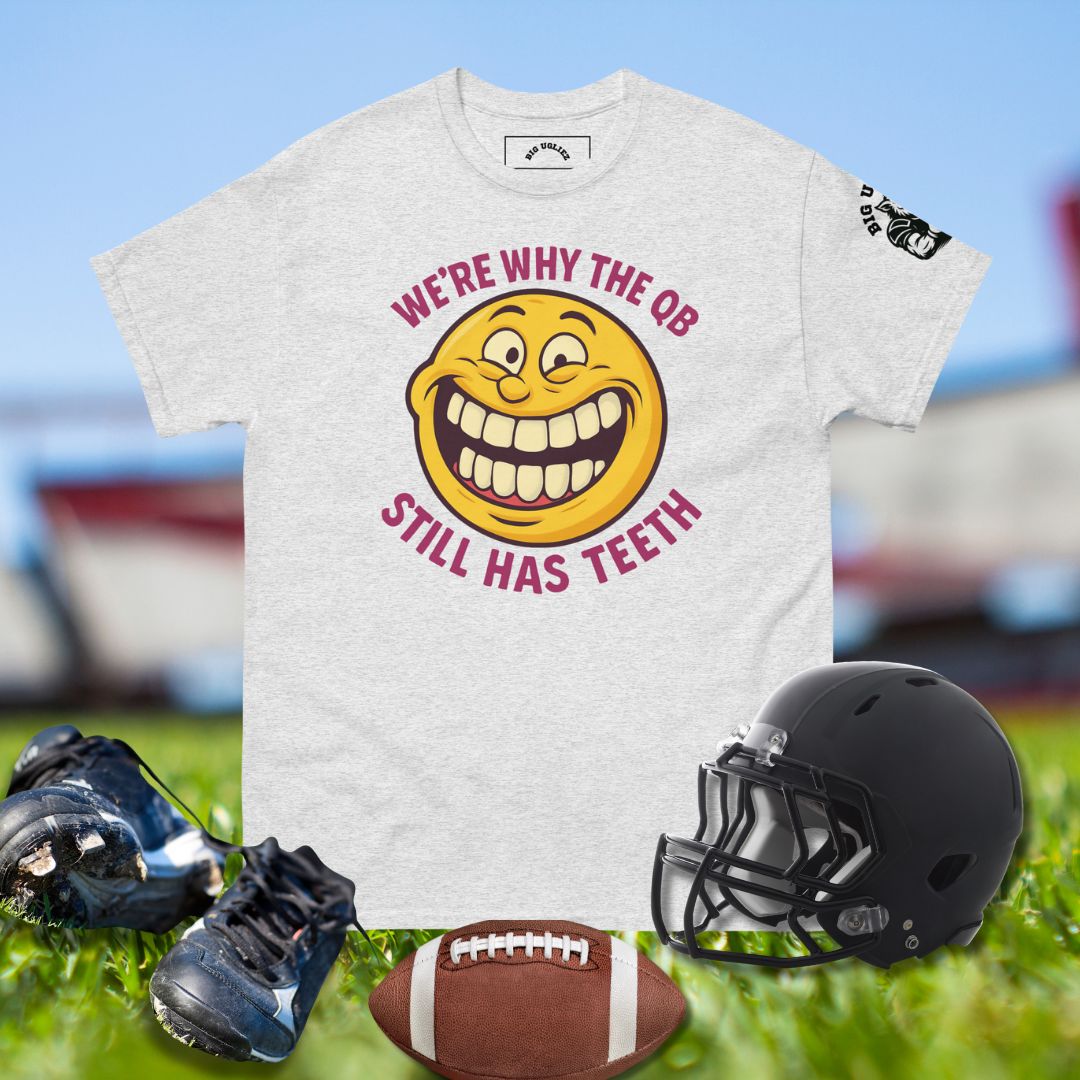 Funny football shirt with yellow smiley face and text We’re Why the QB Still Has Teeth