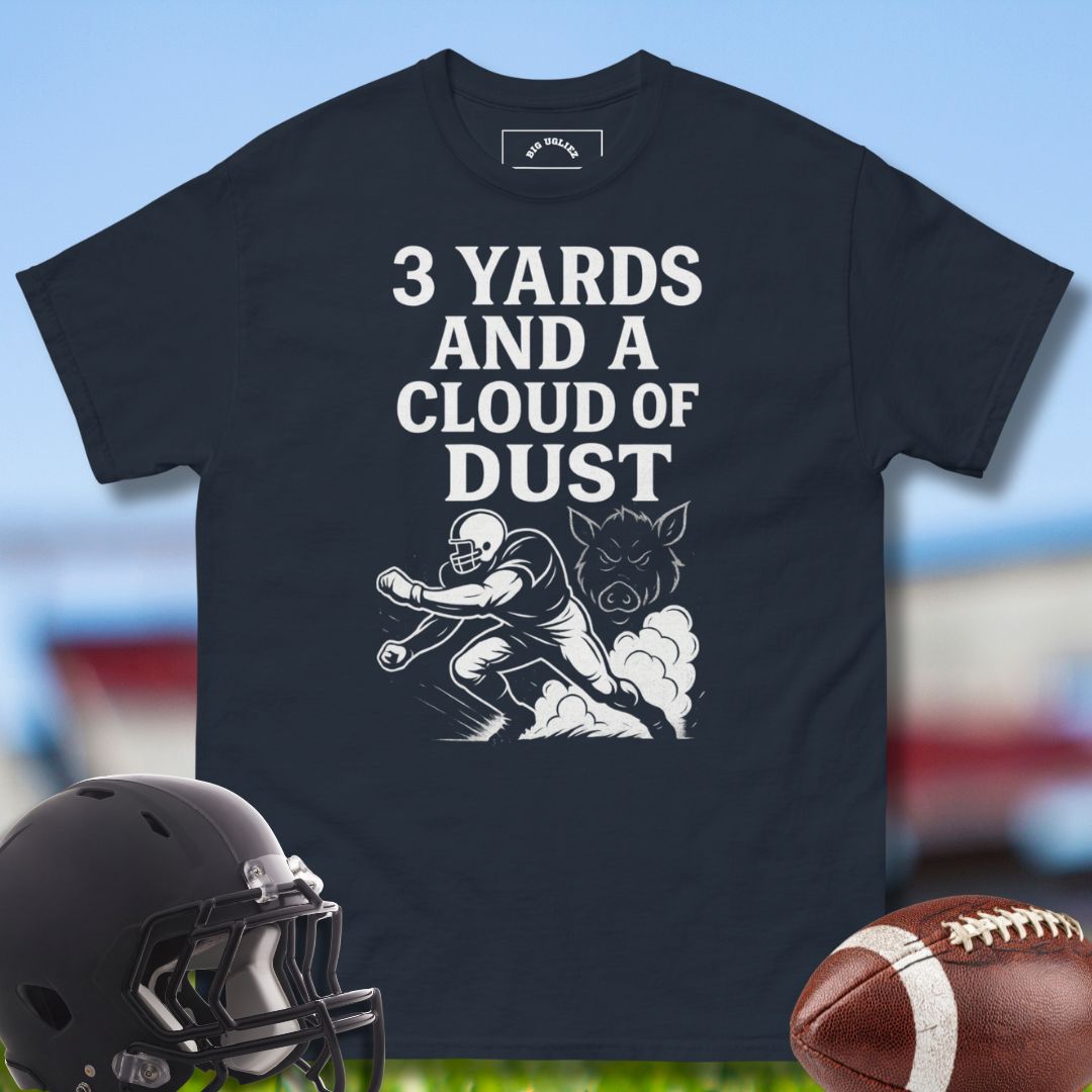 Blue -shirt with football graphic and text, helmet, and football on a sports field background with the design 3 Yards and a Cloud of Dust by Big Ugliez