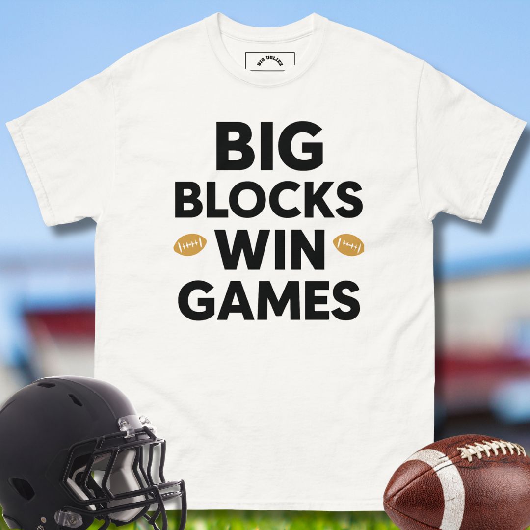 White t-shirt with 'BIG BLOCKS WIN GAMES' text, black helmet, and football on a sports field background