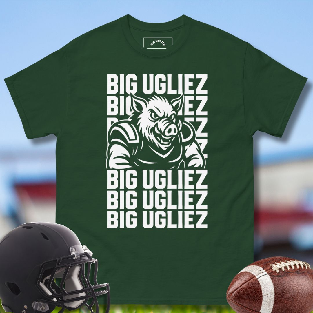 Green t-shirt with 'BIG UGLIEZ' graphic and football helmet and ball on a sports field background