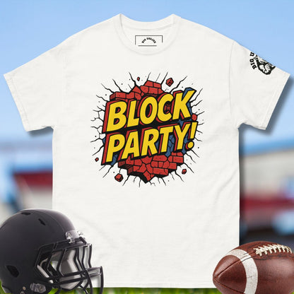 White t-shirt with 'Block Party!' design, black football helmet, and brown football on a blurred sports field background.