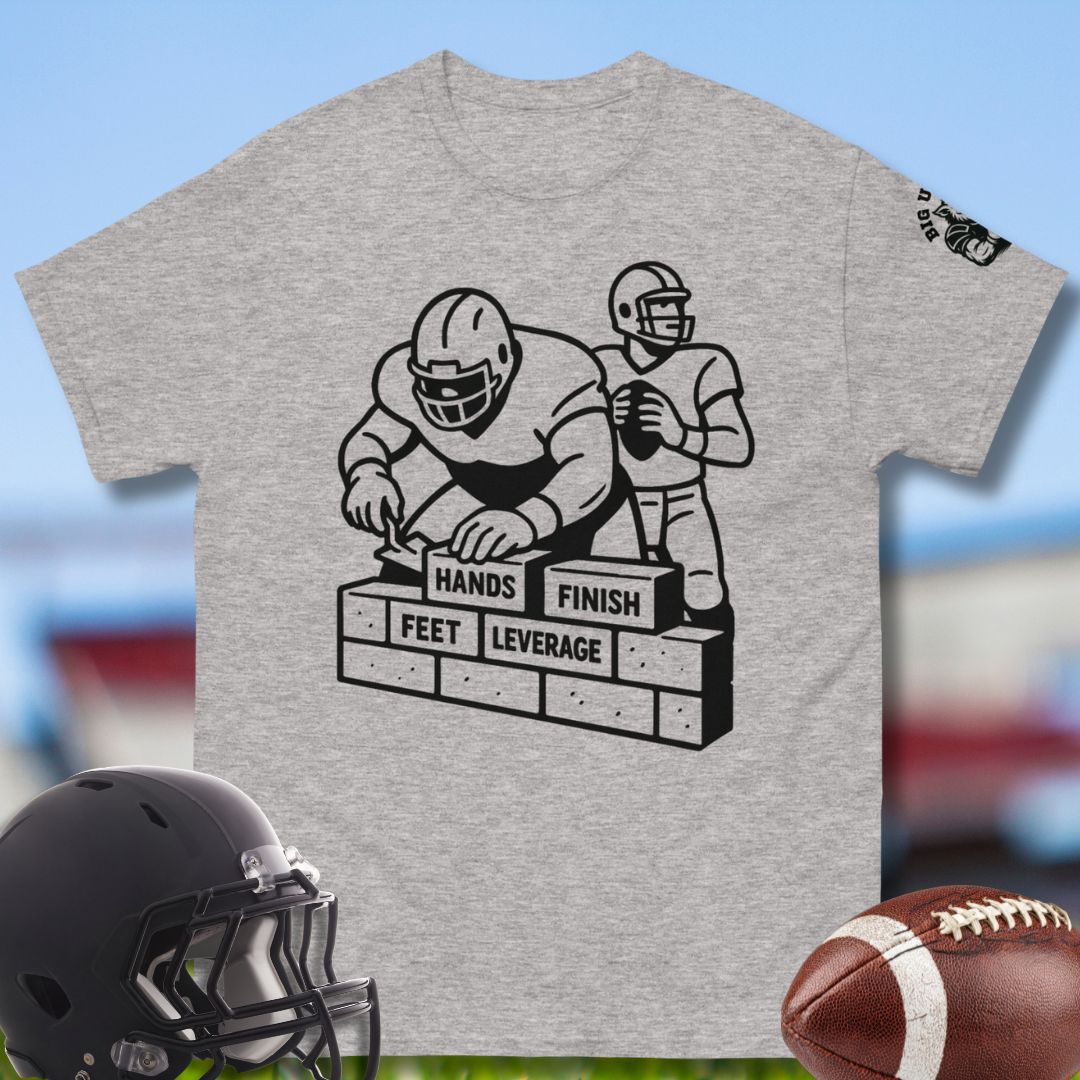 Gray t-shirt with football graphic and text, helmet, and football on a colorful background