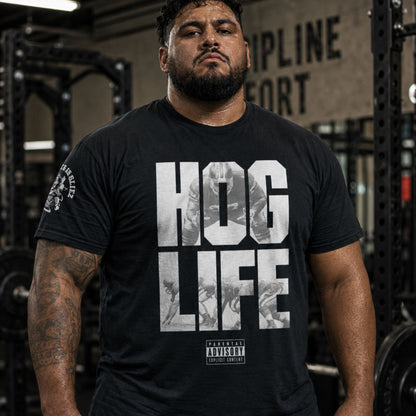 A man wearing a black tshirt with the words Hog_Life By Big Ugliez