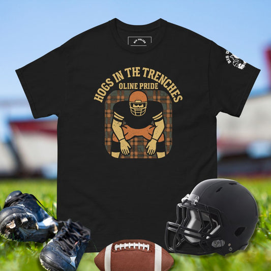 Black t-shirt with football-themed design featuring a helmet, shoes, and ball on grass.