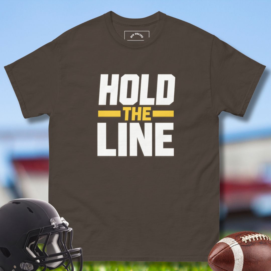 Brown t-shirt with 'Hold the Line' text, football helmet, and football on a sports field background