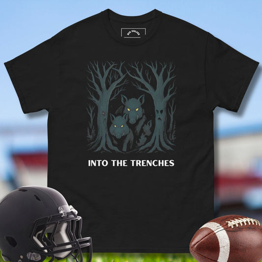 Black t-shirt with wolf design and 'Into the Trenches' text, helmet, and football on a sports field background. Offensive Lineman Tshirt by Big Ugliez