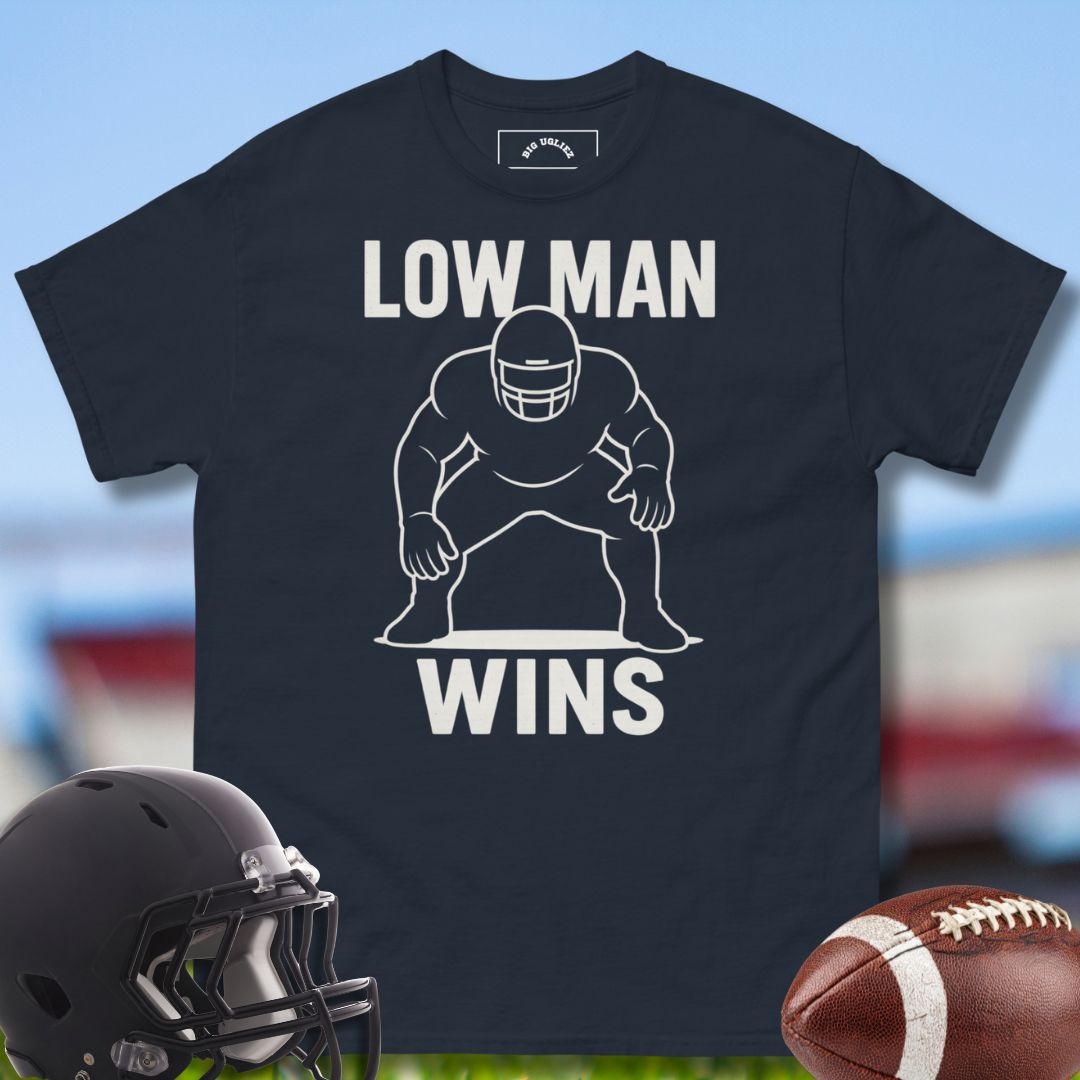 Black t-shirt with 'LOW MAN WINS' graphic, football helmet, and football on a sports field background