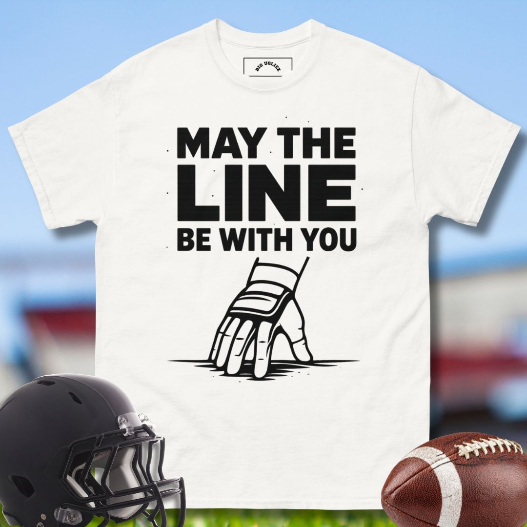 White t-shirt with 'May the Line Be With You' graphic and football helmet and ball on a sports field background - for Olineman football players