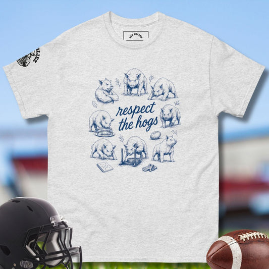 Gray t-shirt with 'respect the hogs' graphic and football helmet and ball on a sports-themed background
