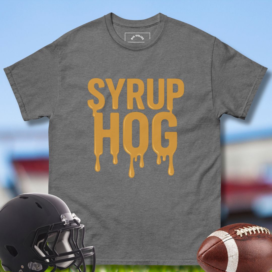 Gray t-shirt with 'Syrup Hog' text, football helmet, and football on a sports field background