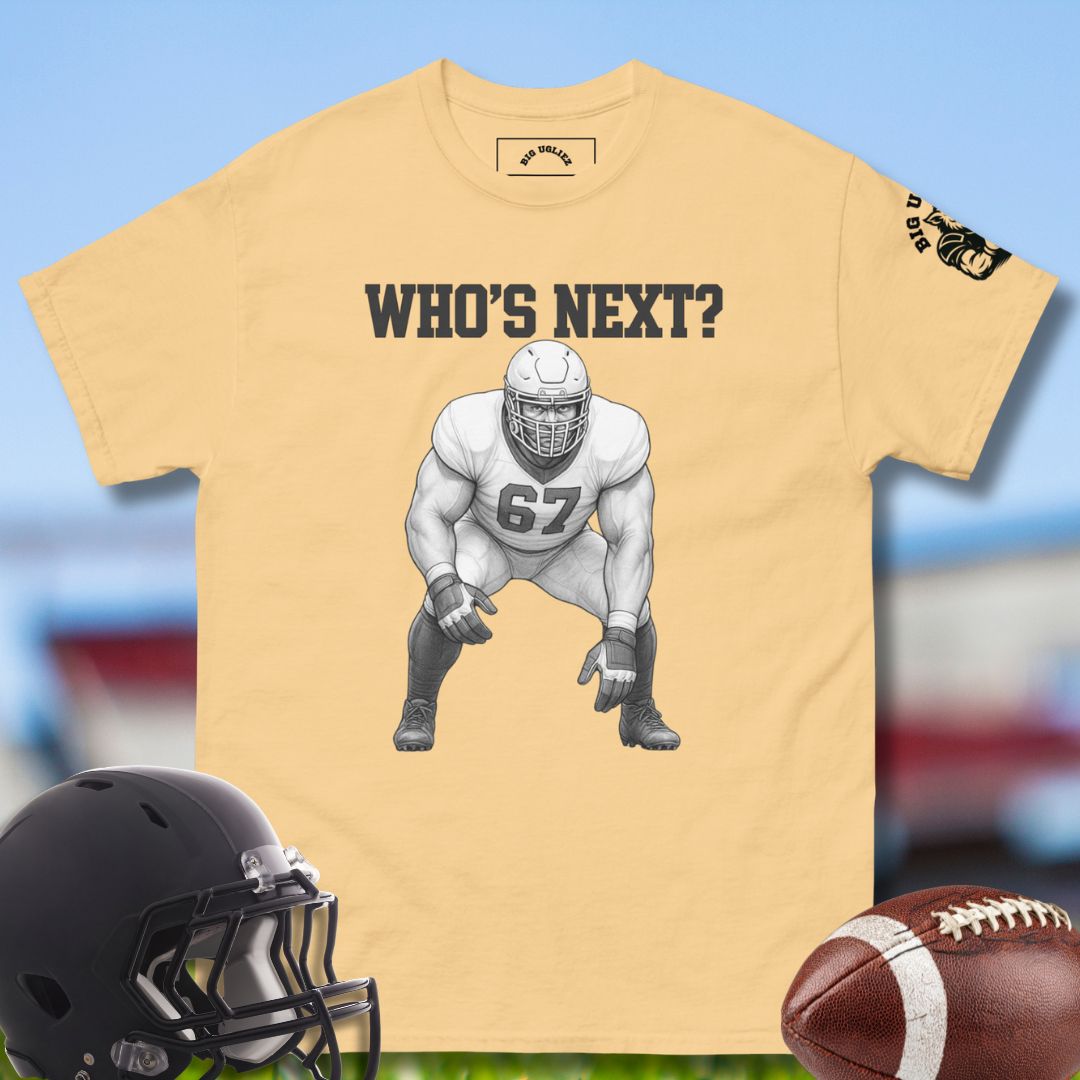 Yellow t-shirt with football player graphic and 'WHO'S NEXT?' text, helmet, and football on a blurred sports field background.