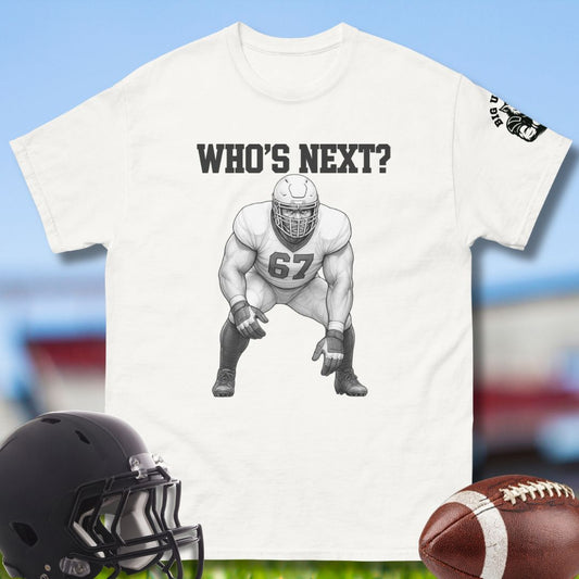 White t-shirt with football player graphic and 'WHO'S NEXT?' text, helmet, and football on a sports-themed background.