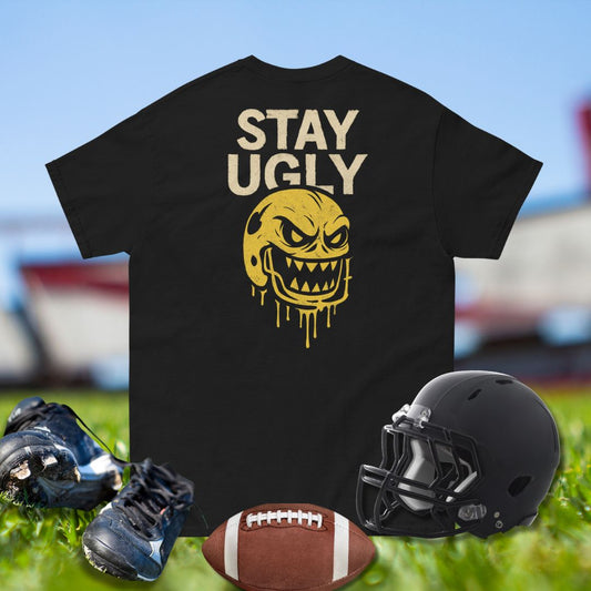 Football shirt with bold Stay Ugly text and fierce yellow dripping helmet