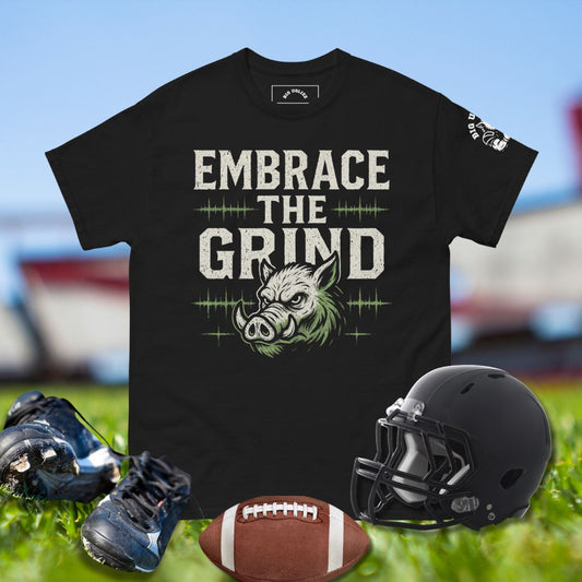 Vintage-style Big Ugliez Embrace the Grind tee featuring bold distressed typography and hog mascot accent in white and neon green for O-linemen and football players.
