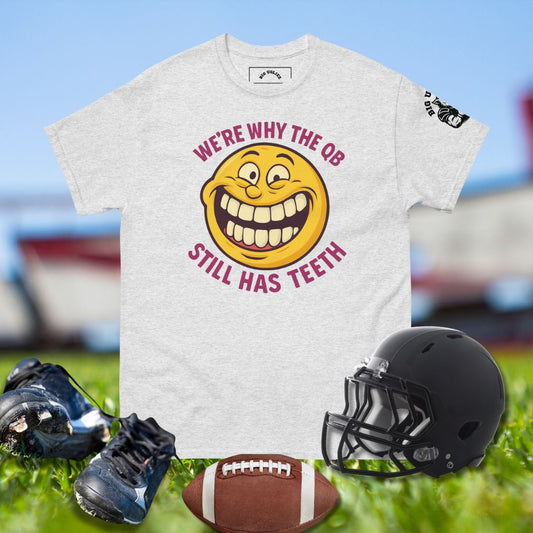 Funny football shirt with yellow smiley face and text We’re Why the QB Still Has Teeth
