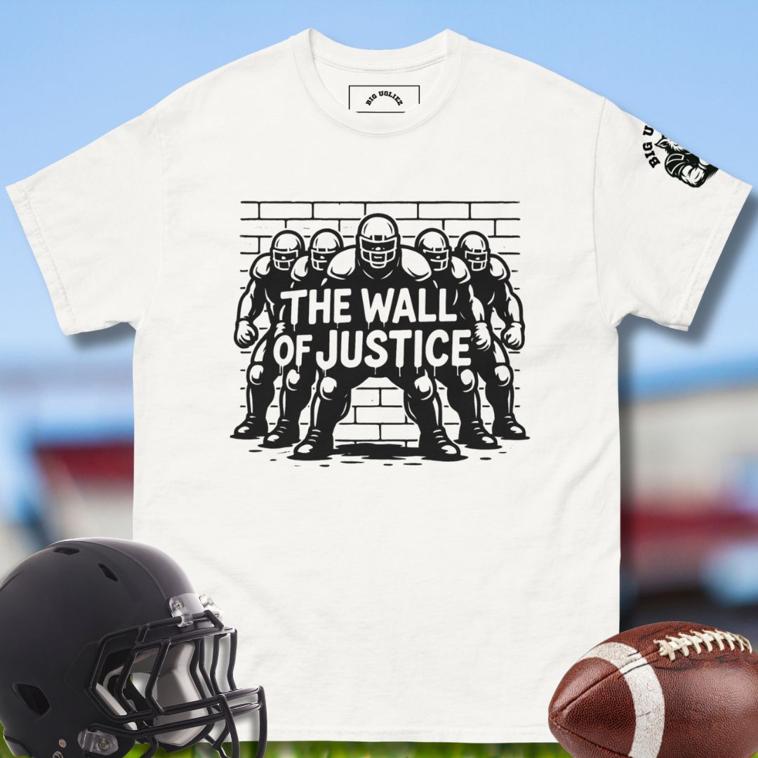 White t-shirt with 'The Wall of Justice' graphic, black football helmet, and brown football on a blurred sports equipment background.