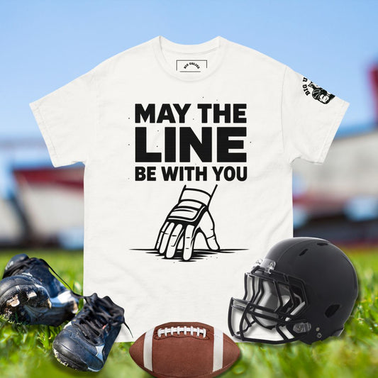 Football lineman hand in 3-point stance with taped wrist and glove under bold text May the Line Be With You in white tshirt